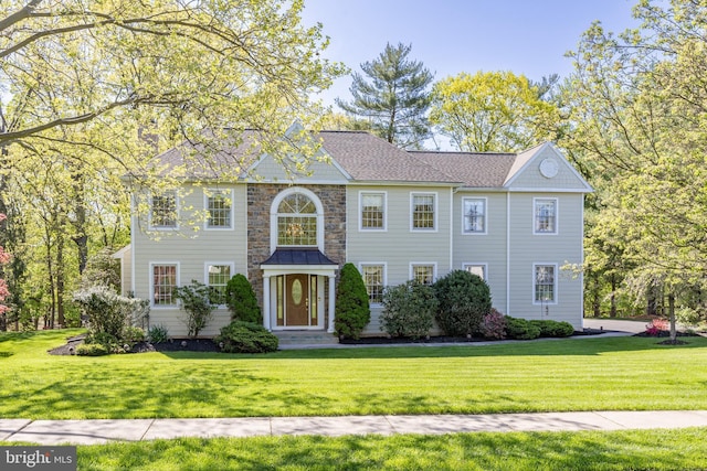 colonial-style house with a front lawn