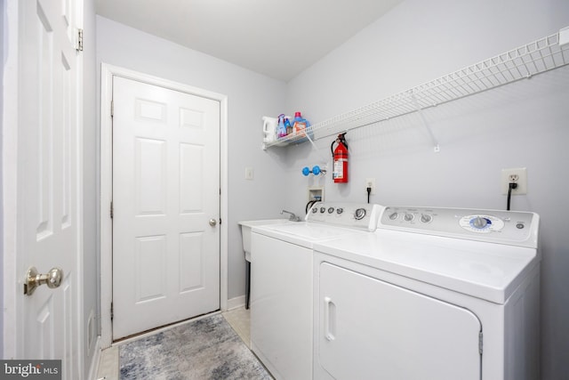 laundry area featuring a sink, laundry area, and washer and dryer