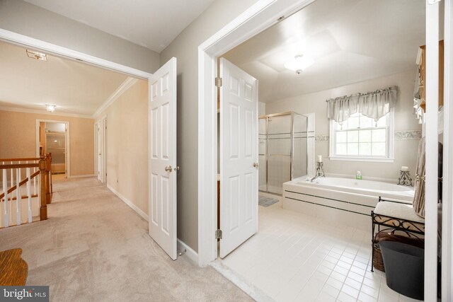hall with crown molding, baseboards, light carpet, and an upstairs landing