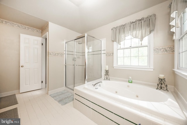 full bath featuring a jetted tub, tile patterned floors, and a shower stall