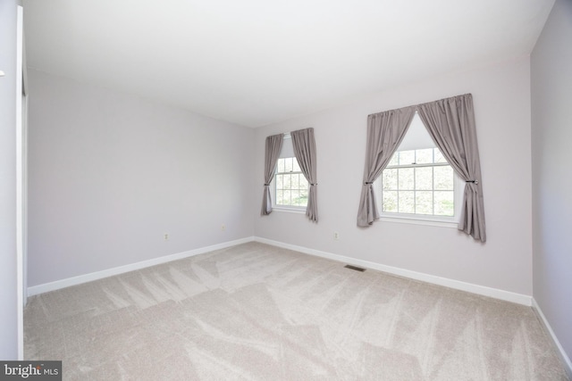 unfurnished room featuring visible vents, baseboards, and carpet floors