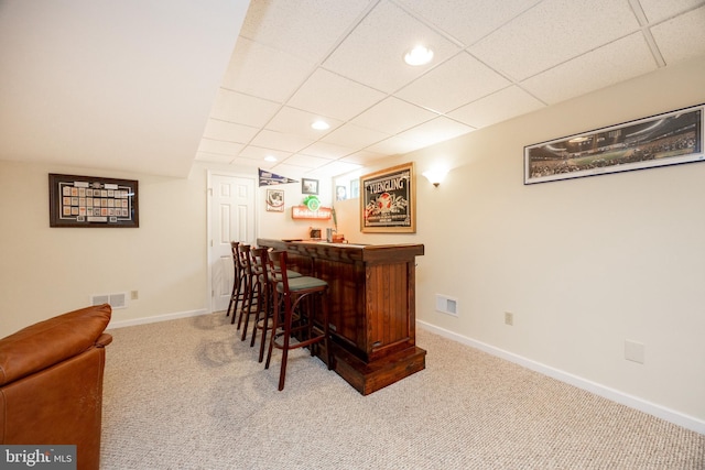 bar featuring visible vents, carpet flooring, recessed lighting, and a bar