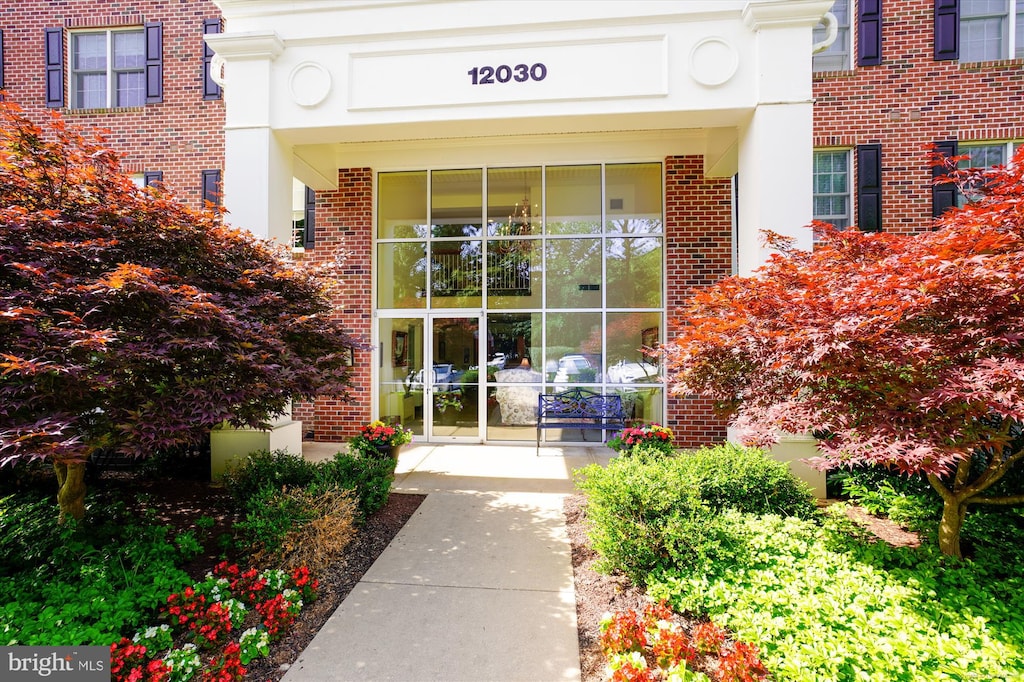 entrance to property featuring brick siding