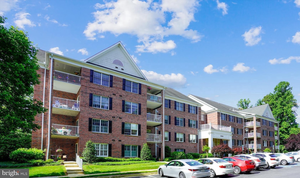 view of building exterior with uncovered parking