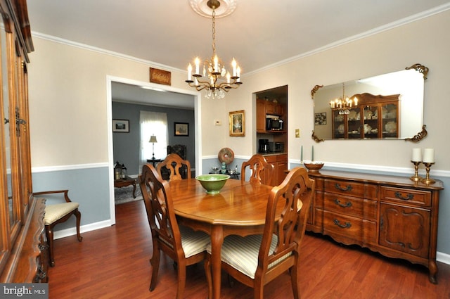 dining room featuring an inviting chandelier, baseboards, ornamental molding, and dark wood-style floors