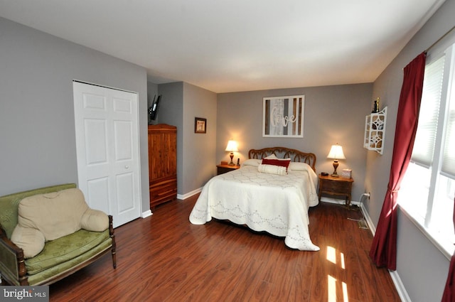 bedroom featuring baseboards and dark wood finished floors
