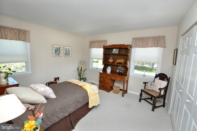 carpeted bedroom featuring baseboards