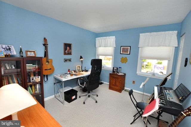 carpeted home office with baseboards