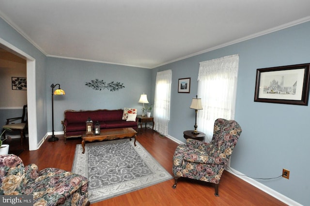 living room with crown molding, baseboards, and wood finished floors