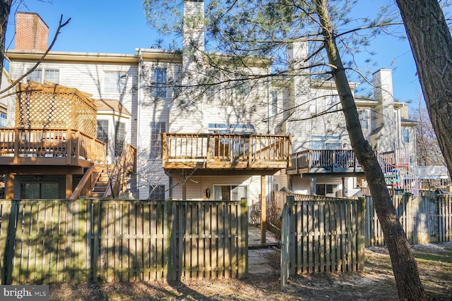 3016 Fallswood Glen Ct, Falls Church, VA 22044 - back of house featuring a chimney, fence private yard, and a wooden deck