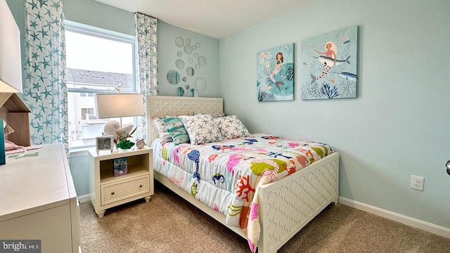 bedroom with carpet floors and baseboards