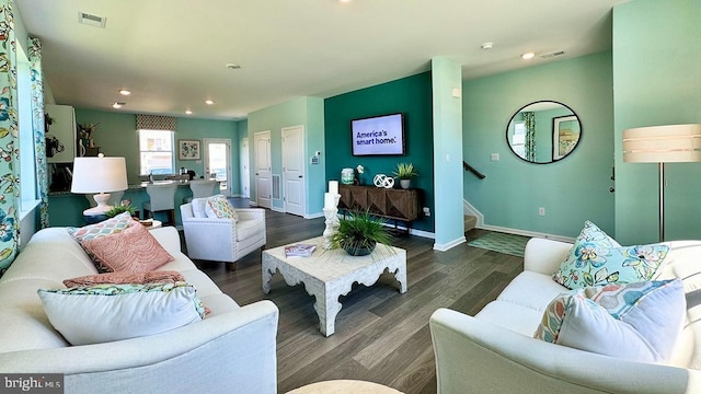 living room featuring visible vents, stairs, wood finished floors, baseboards, and recessed lighting