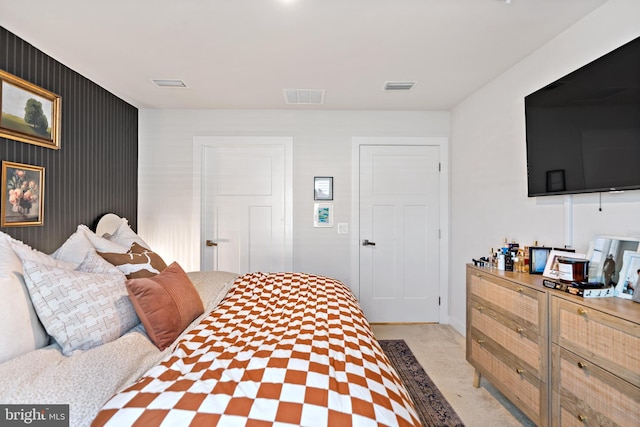 bedroom featuring baseboards, light colored carpet, and visible vents