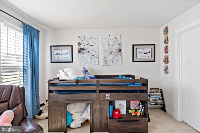 bedroom with baseboards and carpet