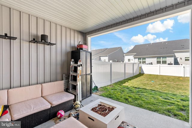 view of patio / terrace with a residential view, a fenced backyard, and a fire pit