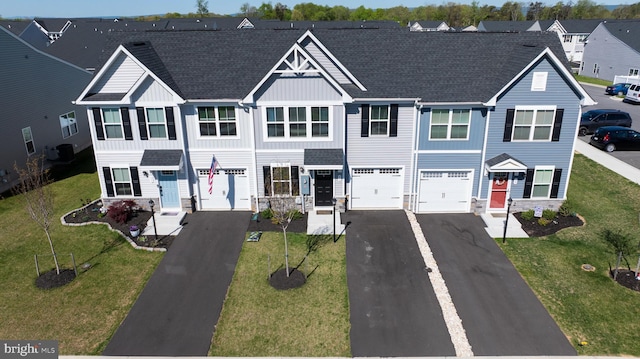 multi unit property featuring roof with shingles, aphalt driveway, a garage, stone siding, and board and batten siding