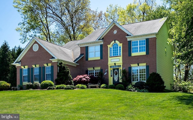 view of front facade featuring a front lawn and brick siding