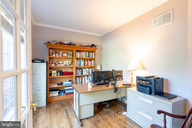 office space with crown molding, wood finished floors, and visible vents