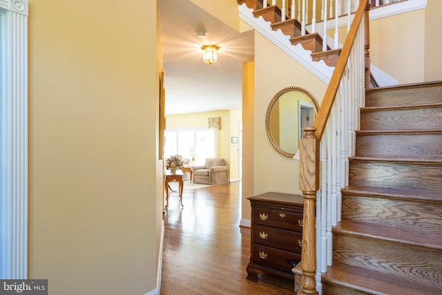 stairway featuring baseboards and wood finished floors