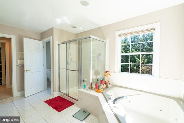 full bath featuring toilet, tile patterned floors, a jetted tub, and a stall shower