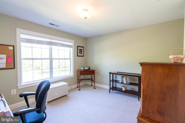 carpeted office space with visible vents and baseboards