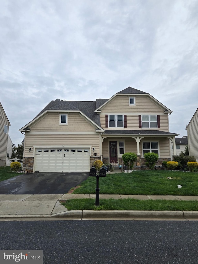 6206 Payton Way, Frederick, MD 21703 - view of front of house featuring stone siding, asphalt driveway, a front lawn, and a garage