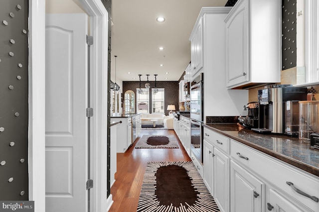 6206 Payton Way, Frederick, MD 21703 - kitchen with dark countertops, white cabinets, and light wood-type flooring
