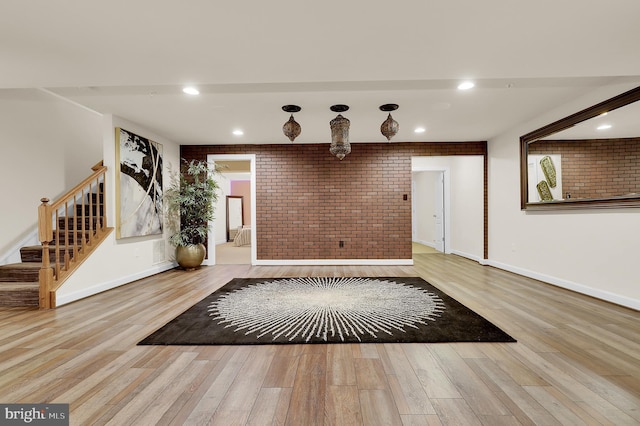 6206 Payton Way, Frederick, MD 21703 - entrance foyer with brick wall, wood finished floors, baseboards, and stairway