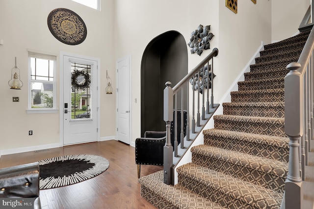 6206 Payton Way, Frederick, MD 21703 - foyer featuring wood finished floors, visible vents, stairway, baseboards, and arched walkways