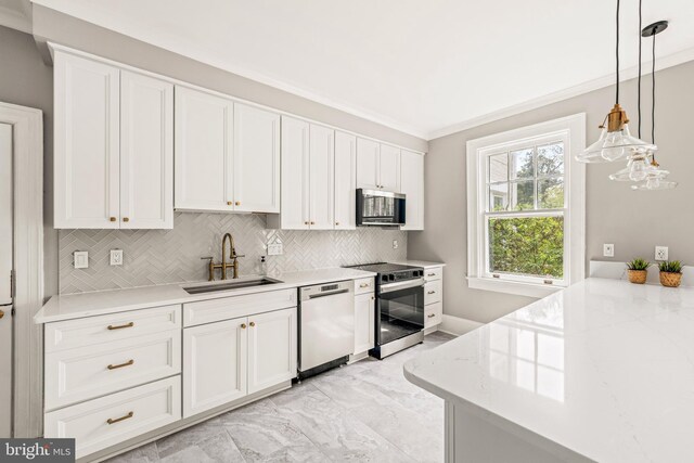 kitchen featuring a sink, appliances with stainless steel finishes, decorative backsplash, and white cabinetry