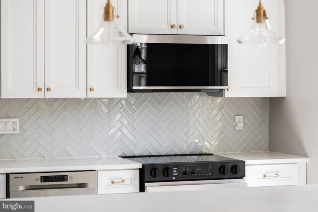 kitchen featuring light countertops, decorative backsplash, stainless steel microwave, and range