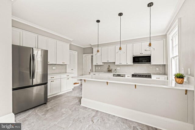 kitchen with stainless steel appliances, white cabinetry, ornamental molding, and marble finish floor