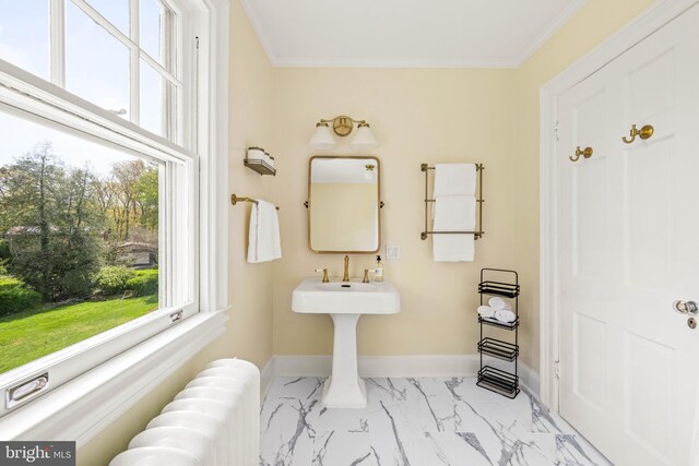 bathroom with crown molding, marble finish floor, radiator, and baseboards