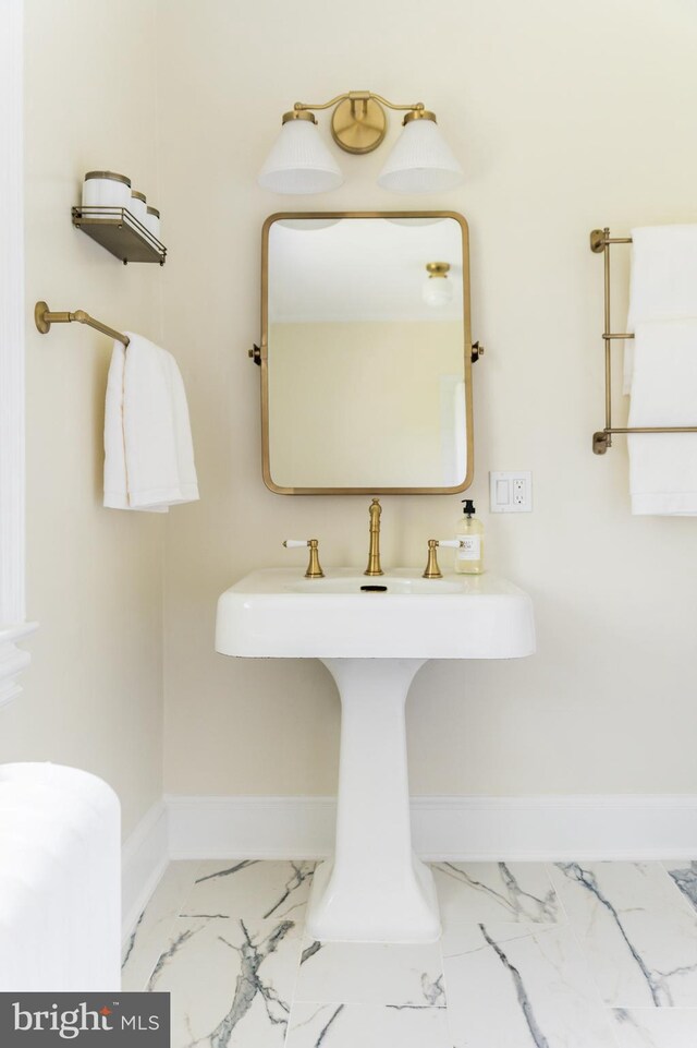 bathroom featuring baseboards and marble finish floor