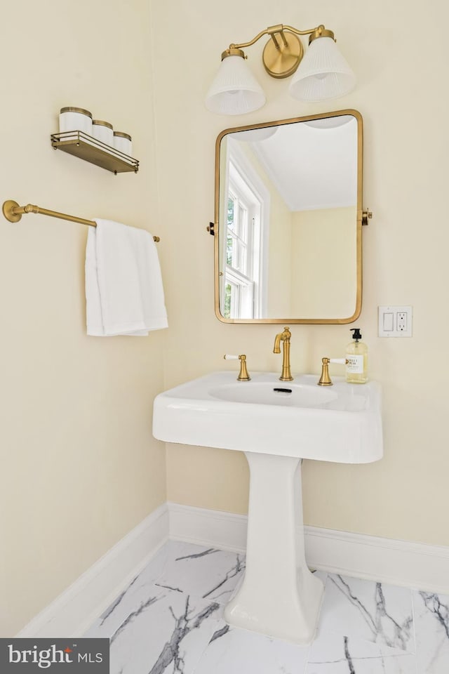 bathroom with baseboards and marble finish floor