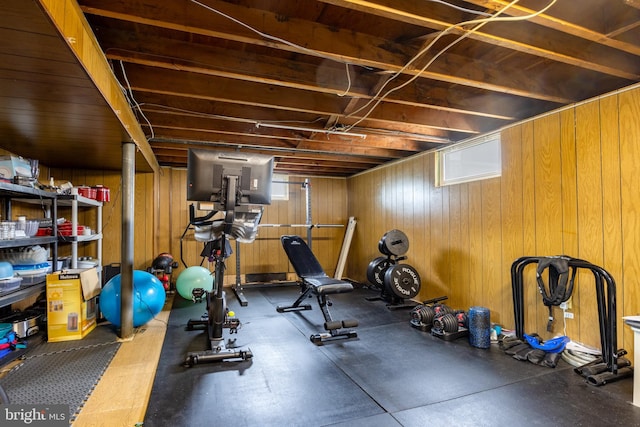 exercise room with wood walls