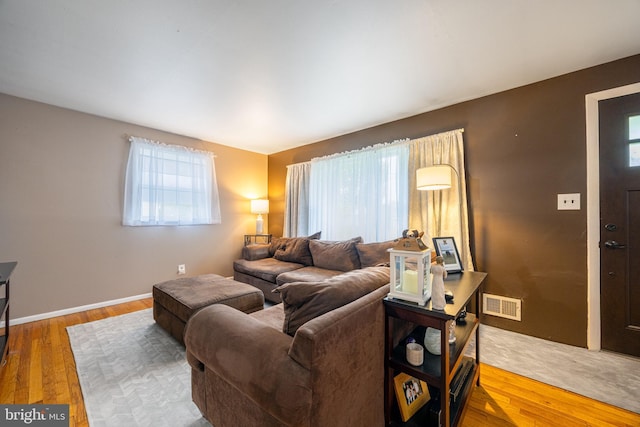 living area with wood finished floors and baseboards