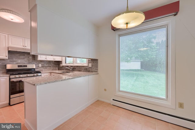 kitchen with gas range, tasteful backsplash, baseboard heating, a sink, and white cabinetry