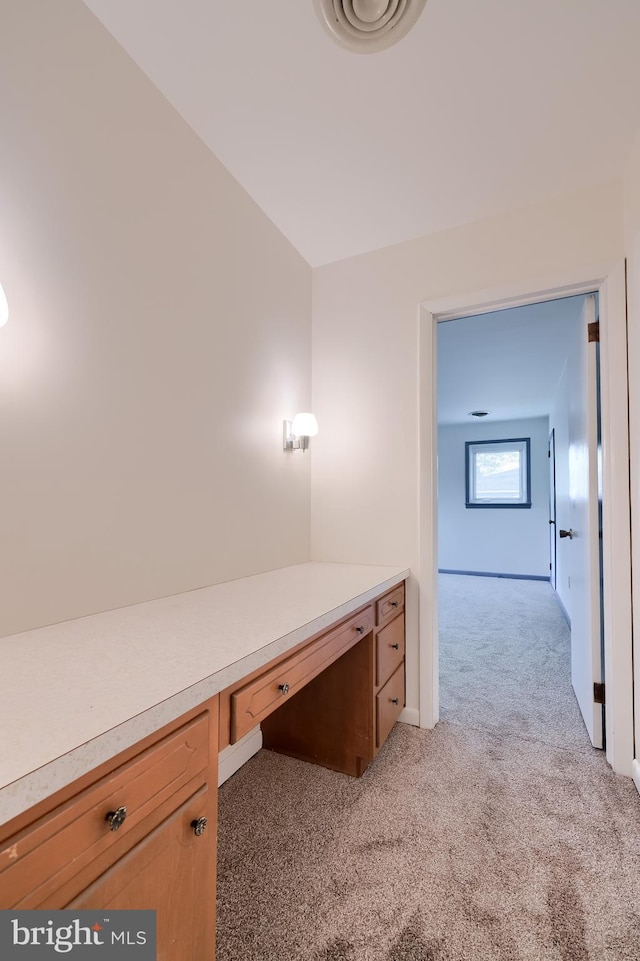 unfurnished office featuring light colored carpet and baseboards