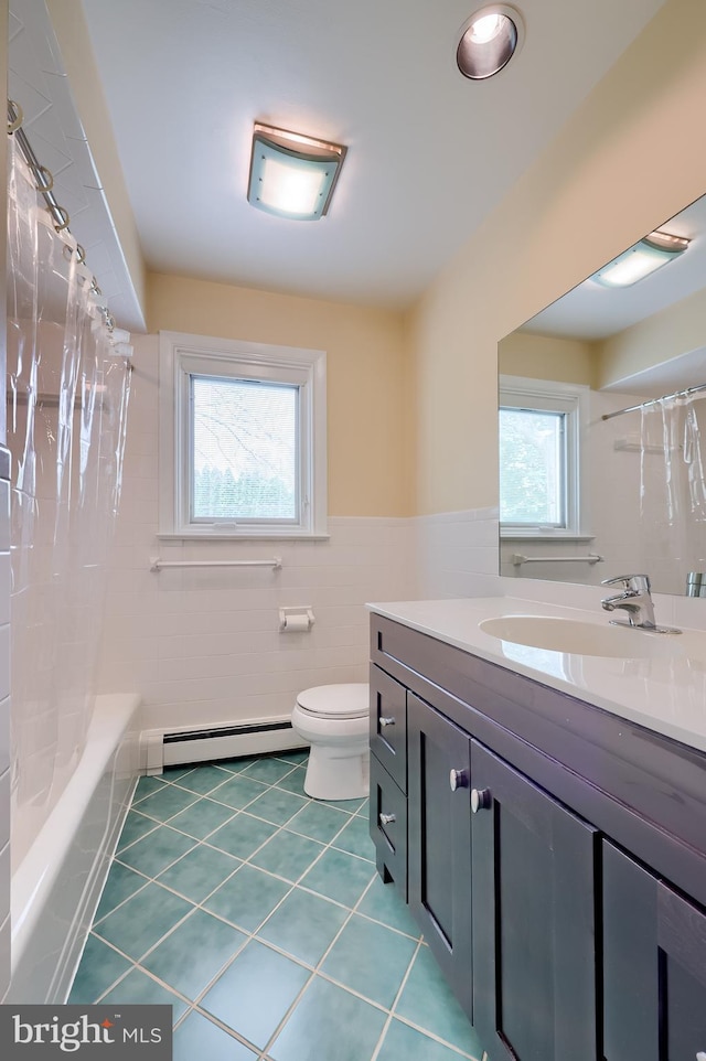 bathroom featuring tile walls, baseboard heating, vanity, tile patterned floors, and toilet