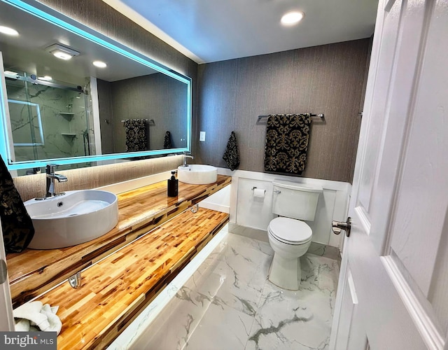 9905 Stoughton Rd, Fairfax, VA 22032 - full bathroom featuring double vanity, toilet, a marble finish shower, a sink, and marble finish floor