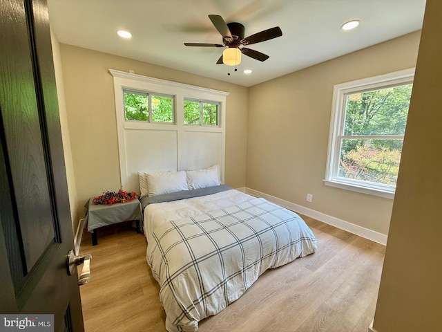 9905 Stoughton Rd, Fairfax, VA 22032 - bedroom featuring baseboards, multiple windows, light wood-style floors, and recessed lighting