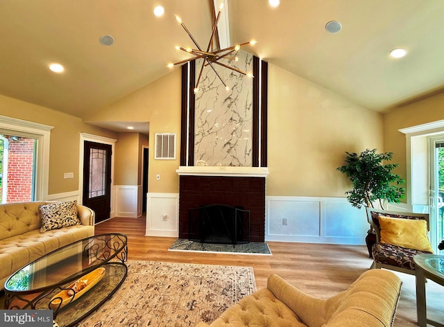 9905 Stoughton Rd, Fairfax, VA 22032 - living room with visible vents, wood finished floors, wainscoting, and high vaulted ceiling