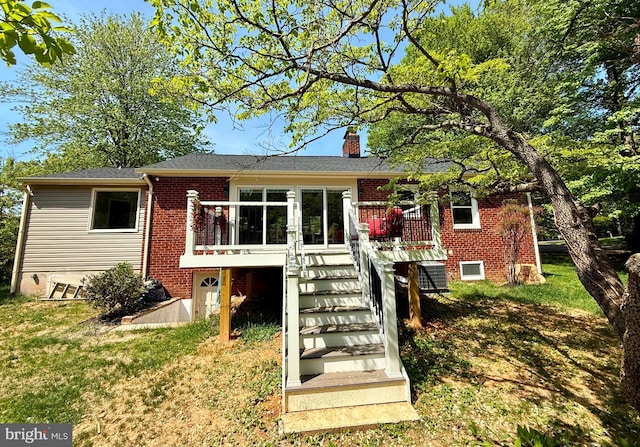9905 Stoughton Rd, Fairfax, VA 22032 - view of front of home with a chimney, brick siding, stairs, a deck, and a front lawn