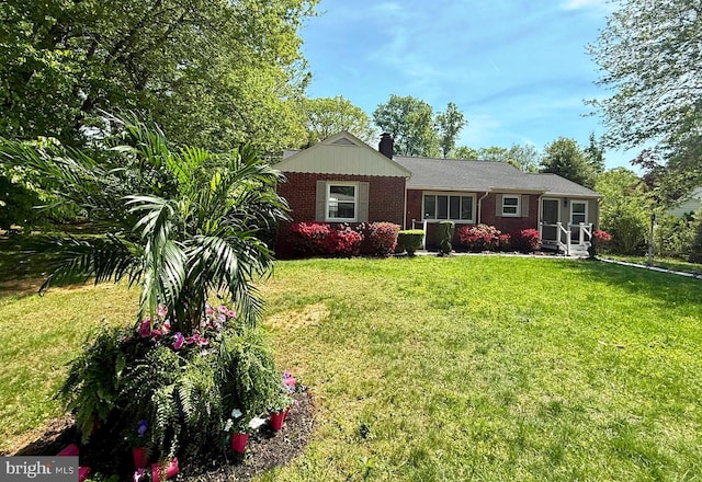 9905 Stoughton Rd, Fairfax, VA 22032 - view of front facade featuring a chimney, a front yard, and brick siding