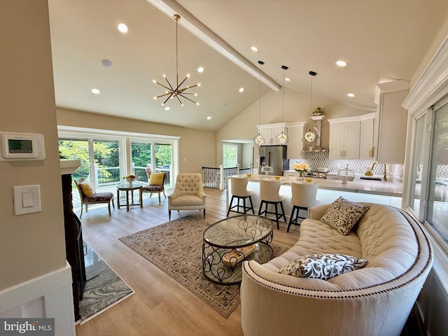9905 Stoughton Rd, Fairfax, VA 22032 - living room with light wood-style flooring, recessed lighting, an inviting chandelier, high vaulted ceiling, and beamed ceiling