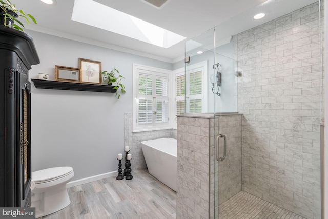 3635 Wessex Ln, Huntingtown, MD 20639 - full bath featuring a skylight, a freestanding bath, ornamental molding, a shower stall, and wood finished floors