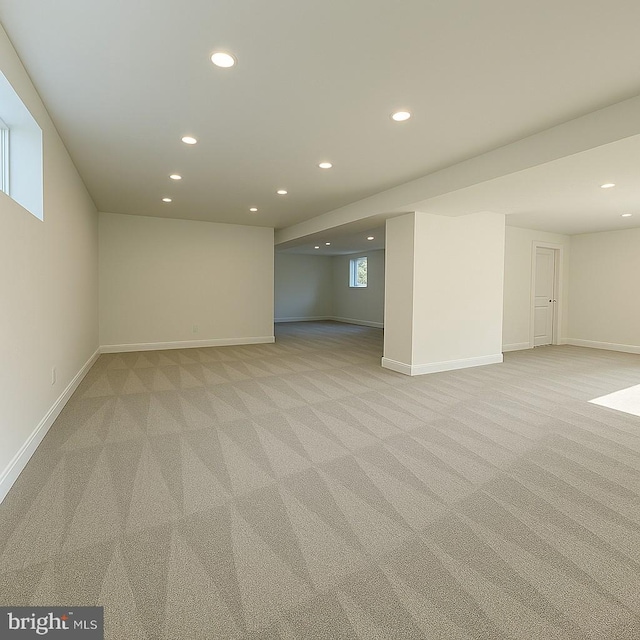basement featuring light colored carpet, recessed lighting, and baseboards