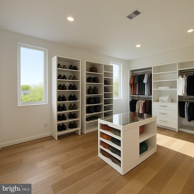 walk in closet featuring light wood-style flooring and visible vents