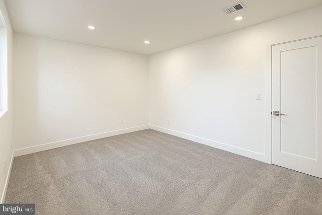 carpeted spare room featuring baseboards, recessed lighting, and visible vents